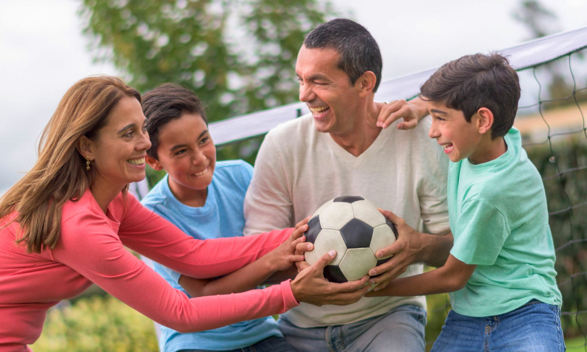 Family playing soccer